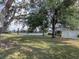 Spacious backyard with large oak trees and pond view at 745 Square Lake E Dr, Bartow, FL 33830