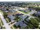 Wide aerial view of neighborhood, showcasing many homes and landscape at 745 Square Lake E Dr, Bartow, FL 33830