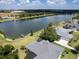 Aerial view of lakefront property with houses and dock at 745 Square Lake E Dr, Bartow, FL 33830