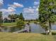 Serene pond view with a wooden dock at 745 Square Lake E Dr, Bartow, FL 33830