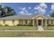 Ranch-style home with gray roof and yellow siding at 745 Square Lake E Dr, Bartow, FL 33830