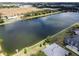 Aerial view of property with lake and diving platform at 745 Square Lake E Dr, Bartow, FL 33830