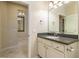 Bathroom with vanity, mirror, and access to another room at 8288 Lake James Dr, Lakeland, FL 33810