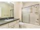 Clean bathroom with a tub, shower, and dark vanity at 8288 Lake James Dr, Lakeland, FL 33810