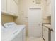 Laundry room with washer, dryer, cabinets, and sink at 8288 Lake James Dr, Lakeland, FL 33810