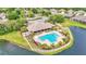 Aerial view of community pool and clubhouse near the lake at 8288 Lake James Dr, Lakeland, FL 33810