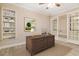 Home office with built-in shelving and hardwood flooring at 8288 Lake James Dr, Lakeland, FL 33810