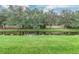 Tranquil waterfront view with lush green grass and mature trees at 8288 Lake James Dr, Lakeland, FL 33810