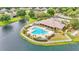 Aerial view of community pool and clubhouse near a lake at 8288 Lake James Dr, Lakeland, FL 33810