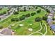 Aerial view of community with golf course, houses, and landscaping at 5879 Swallow Dr, Lakeland, FL 33809