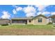 Single-story house with screened porch and grassy backyard at 5879 Swallow Dr, Lakeland, FL 33809
