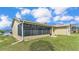 Spacious backyard with screened enclosure and lush lawn at 5879 Swallow Dr, Lakeland, FL 33809
