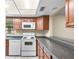 Galley kitchen with wood cabinets and appliances at 2025 Sylvester Rd # C4, Lakeland, FL 33803
