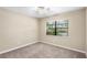 Well-lit bedroom featuring a large window and carpeted floor at 2025 Sylvester Rd # C4, Lakeland, FL 33803