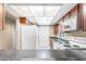 Kitchen with wood cabinets, white appliances, and granite countertops at 2025 Sylvester Rd # C4, Lakeland, FL 33803