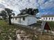 Front view of a freshly painted house with a chain link fence and manicured landscaping at 143 D St, Lake Wales, FL 33853
