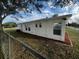Side yard view of a newly renovated house with landscaping at 143 D St, Lake Wales, FL 33853