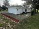 Newly painted house exterior with chain link fence and landscaped yard at 143 D St, Lake Wales, FL 33853