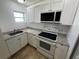 Modern kitchen with white cabinets and granite counters at 143 D St, Lake Wales, FL 33853