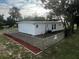 Newly painted house exterior with chain link fence and landscaped yard at 143 D St, Lake Wales, FL 33853