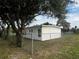 Side yard view of a newly renovated house with chain link fence at 143 D St, Lake Wales, FL 33853