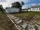 Front yard with walkway leading to a newly renovated house at 143 D St, Lake Wales, FL 33853