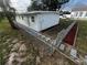 Exterior view showing the home and landscaping at 143 D St, Lake Wales, FL 33853