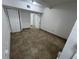 Spacious bedroom with tile flooring and double doors leading to a hallway at 143 D St, Lake Wales, FL 33853