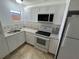 Updated kitchen with white cabinets, new appliances, and granite countertops at 143 D St, Lake Wales, FL 33853