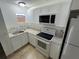 Updated kitchen with white cabinets, new appliances, and granite countertops at 143 D St, Lake Wales, FL 33853
