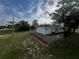 Newly renovated house exterior with fenced yard and landscaping at 143 D St, Lake Wales, FL 33853