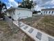 White house exterior with new walkway and chain link fence at 143 D St, Lake Wales, FL 33853