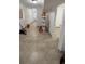 Unfinished hallway with tile floors and paint supplies at 143 D St, Lake Wales, FL 33853