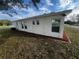Side yard view of a newly renovated house with landscaping at 143 D St, Lake Wales, FL 33853