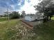 Newly renovated house exterior with a fenced yard and landscaping at 143 D St, Lake Wales, FL 33853