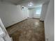Simple bedroom with tile floors and a door to hallway at 143 D St, Lake Wales, FL 33853