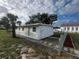 Recently renovated house exterior with a chain link fence and freshly laid mulch at 143 D St, Lake Wales, FL 33853