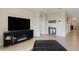 Spacious living area with a large TV, fireplace, and access to hallway at 5600 Siltstone St, Lakeland, FL 33811