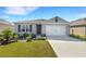 One-story house with a two-car garage and landscaped yard at 5600 Siltstone St, Lakeland, FL 33811
