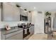 Modern kitchen with gray cabinets, granite countertops, and stainless steel appliances at 5600 Siltstone St, Lakeland, FL 33811