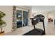 Bright home gym features a treadmill and access to a bedroom and patio at 5600 Siltstone St, Lakeland, FL 33811