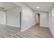 Long hallway with hardwood floors and neutral walls at 401 Sw 1St Ave, Mulberry, FL 33860