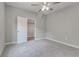 Bright bedroom with grey walls, ceiling fan, and walk-in closet at 401 Sw 1St Ave, Mulberry, FL 33860