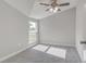 Bright bedroom featuring neutral walls, carpet flooring, and a ceiling fan at 401 Sw 1St Ave, Mulberry, FL 33860