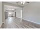 Open living room with hardwood floors and a view into the kitchen area at 401 Sw 1St Ave, Mulberry, FL 33860