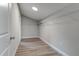 Large walk-in closet with wire shelving and wood-look flooring at 401 Sw 1St Ave, Mulberry, FL 33860