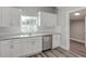 Updated kitchen with white cabinets, stainless steel dishwasher, and granite countertops at 401 Sw 1St Ave, Mulberry, FL 33860