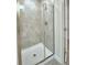 Walk-in shower with glass enclosure and neutral tile at 5496 Knights Landing Dr, Lakeland, FL 33810