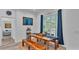 Farmhouse style dining area with wooden table and bench, near bedroom at 7365 Millbrook Oaks Dr, Lakeland, FL 33813