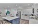 Modern kitchen with white cabinets, quartz countertops and a blue island at 7365 Millbrook Oaks Dr, Lakeland, FL 33813
